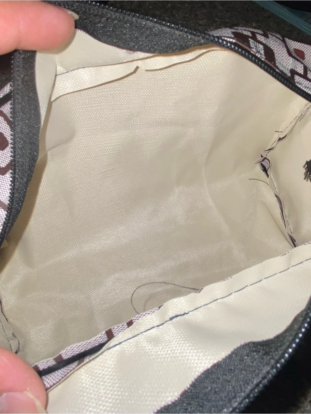 Brown and white geometric patterned travel toiletry bag